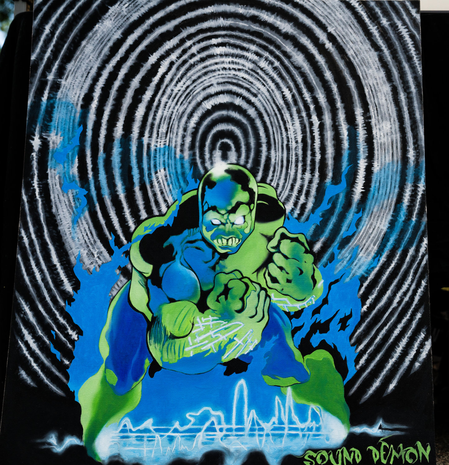 Ken Jackson’s superhero-inspired work invites the viewer into a world of powerful but misunderstand beings that are desperate to convey their strengths, but destined to reveal their weaknesses. The tantalizing, thumbprint-like background of the piece is engaging and maddening to the viewer as it aims to hypnotize and destabilize.